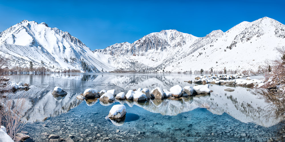convict lake with snow on the mountains and blue sky