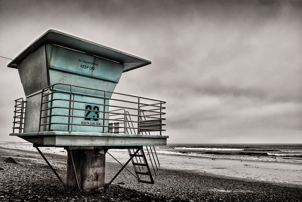 "See Me At 23" is a photograph of the number 23 lifeguard tower in Carlsbad, California by Roy Kerckhoffs.