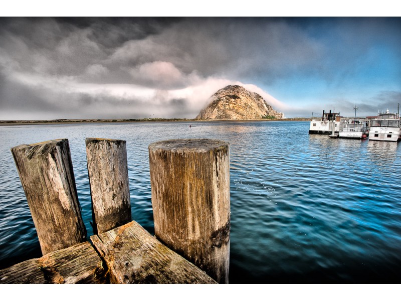 morro rock in distance with wooden pier in foreground