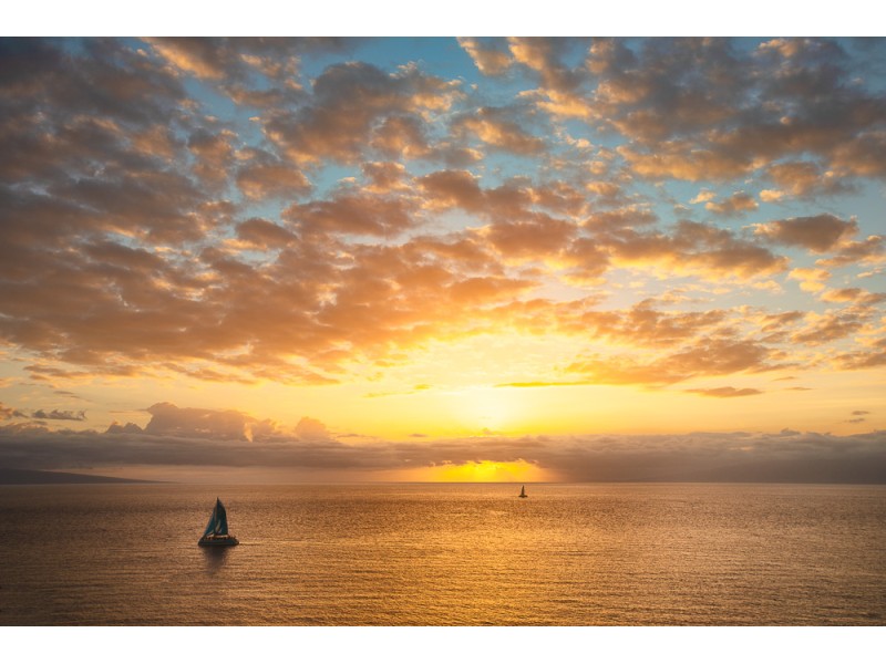 Hawaii sunset with clouds and catamarans on ocean