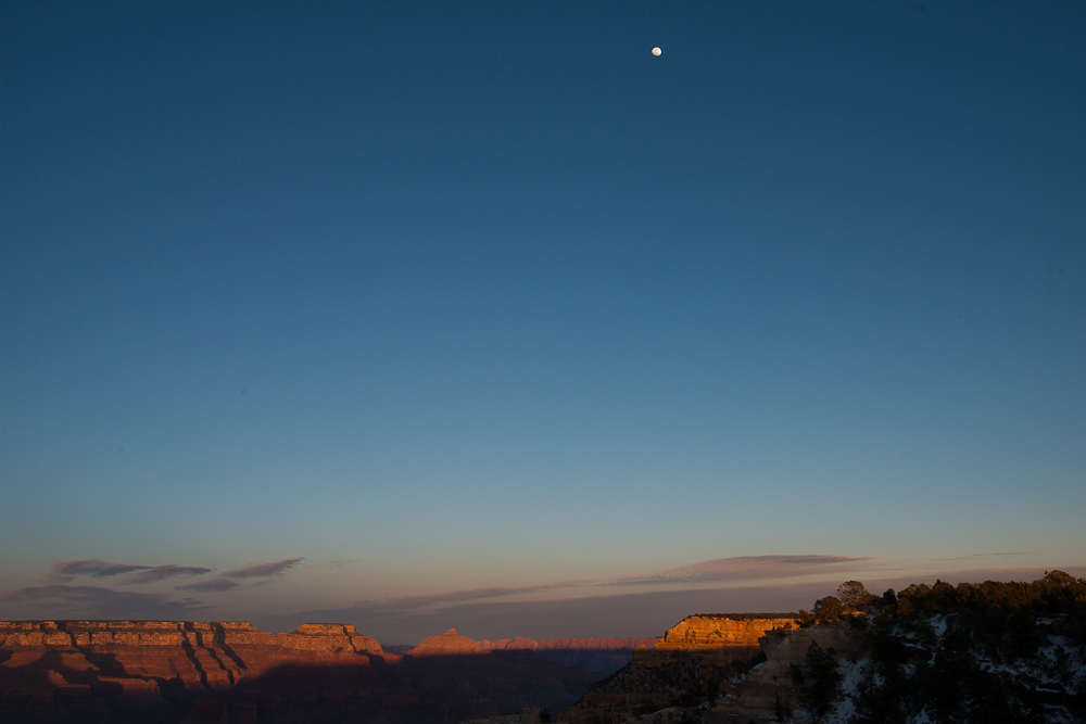 arizona setting sun and rising moon over grand canyon