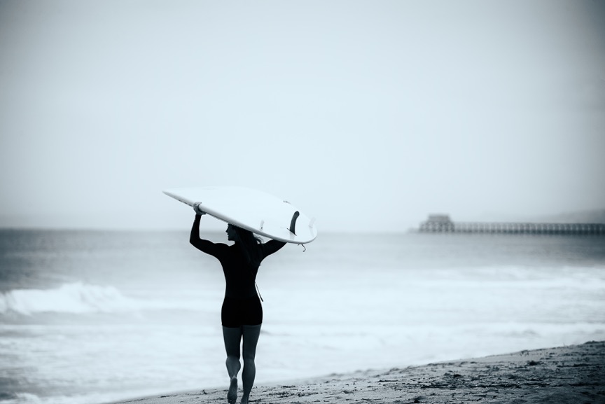 "Jennifer" is a photograph by Roy Kerckhoffs of a female surfer on a beach in San Diego, California.