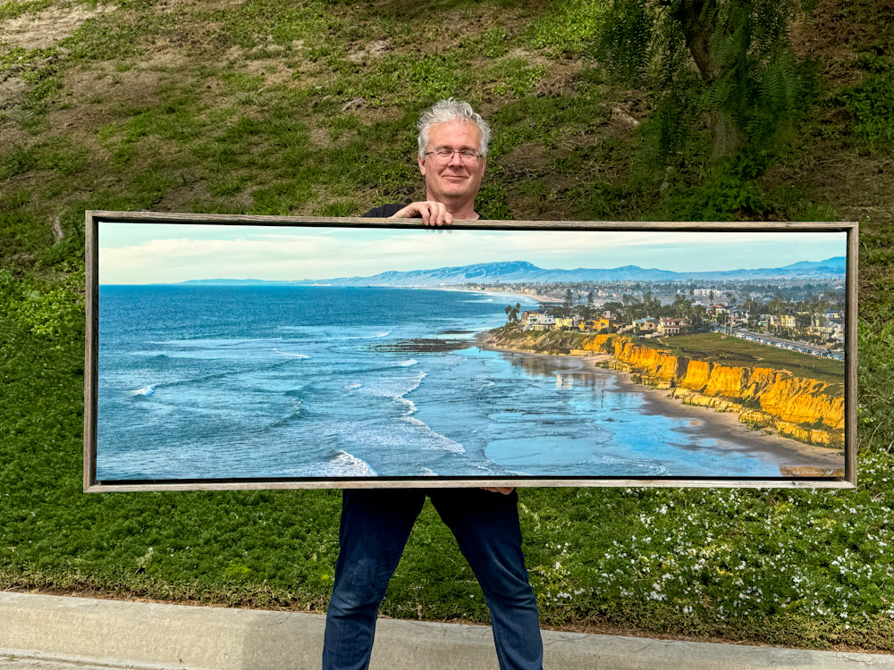 roy holding 24x72 people of terra mar on canvas