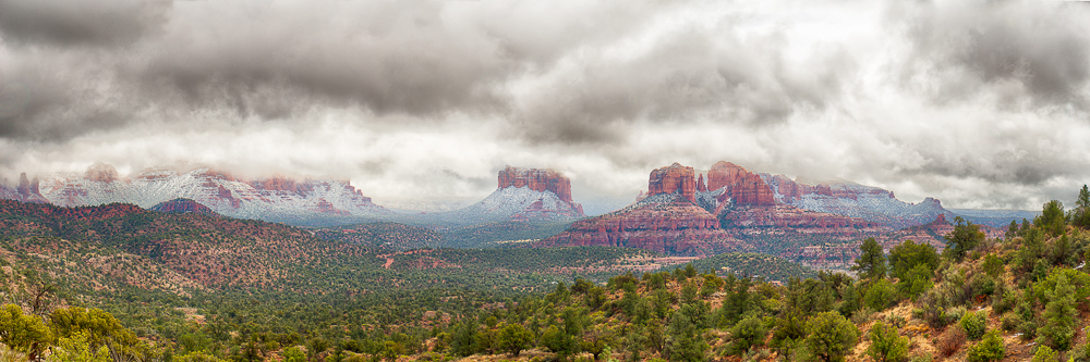 sedona arizona cathedral rock in distance with snow and clouds