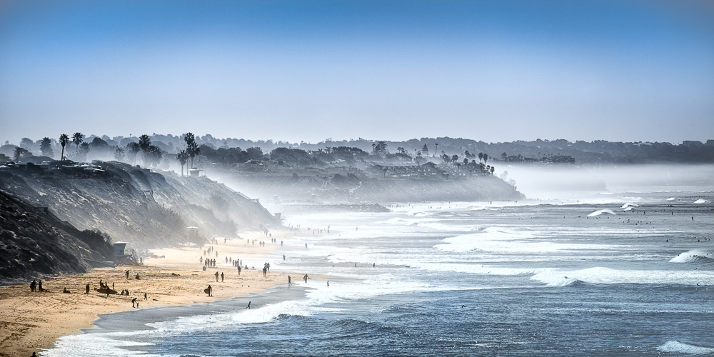 view of south carlsbad state beach with people on beach and fog