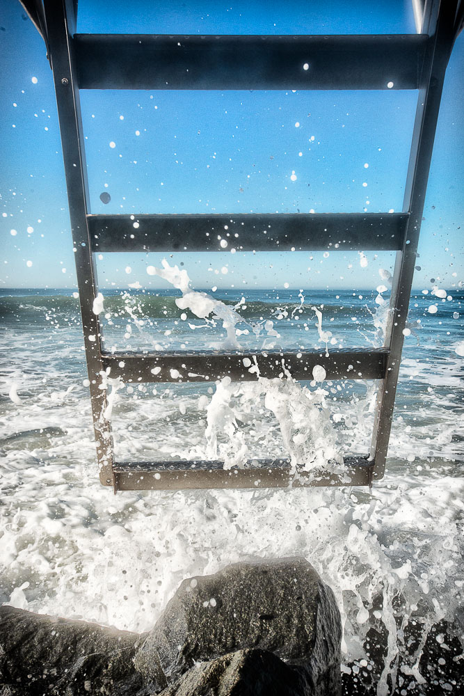 waves hitting ladder of lifeguard tower